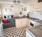 Housemate sat at breakfast bar in student property kitchen.